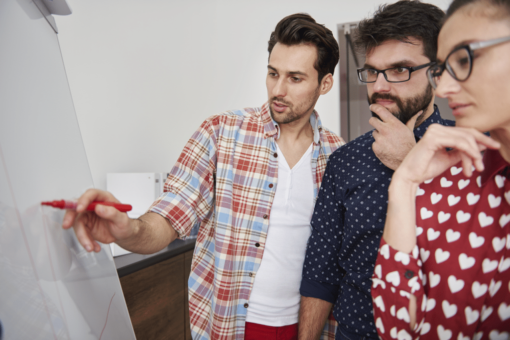 This scene illustrates a brainstorming session or collaborative effort, where overcoming psychological inertia is essential for generating new ideas and solutions.
